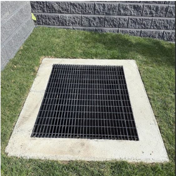 "Industrial Traffic-Rated Grating: Installation of high-load steel floor grating for mechanical shafts and parkade ventilation. Features a custom-fit drop-in design with a slip-resistant serrated surface"
